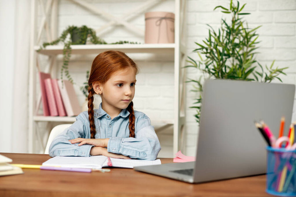 little child girl using laptop for studying online - Foto, imagen