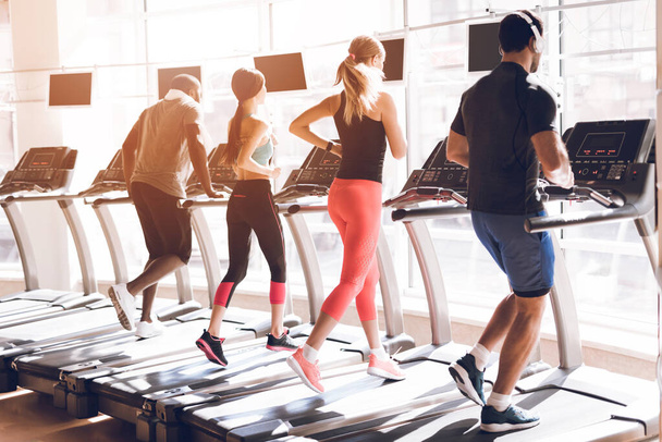 Strong people athletes on treadmills run together. - Foto, Imagen