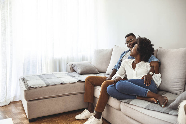 Young family couple together at home casual. Young woman and man family couple indoors relaxation. Being together is the best place to be. Shot of a young couple relaxing at home - Fotó, kép