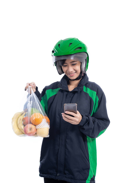 female uber delivery courier wearing helmet - Fotografie, Obrázek