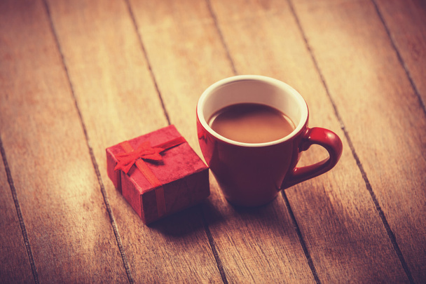 Red cup of the coffee and little gift.  - Photo, Image
