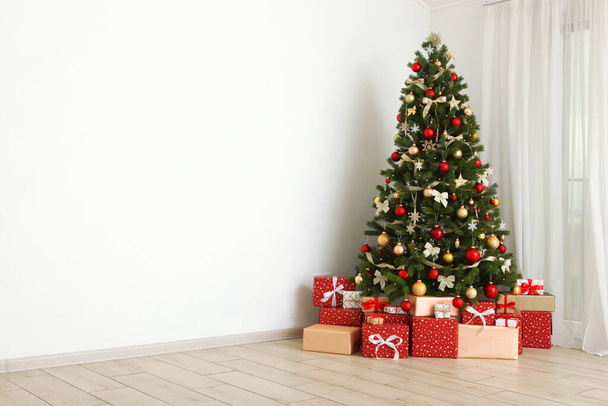 Beautiful interior decorated for Christmas or New Year. Christmas tree and gifts. Place for text - Photo, Image