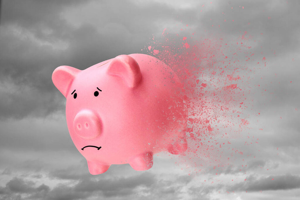 No money or savings have disappeared. Piggy bank turns into sand against the sky - Photo, Image