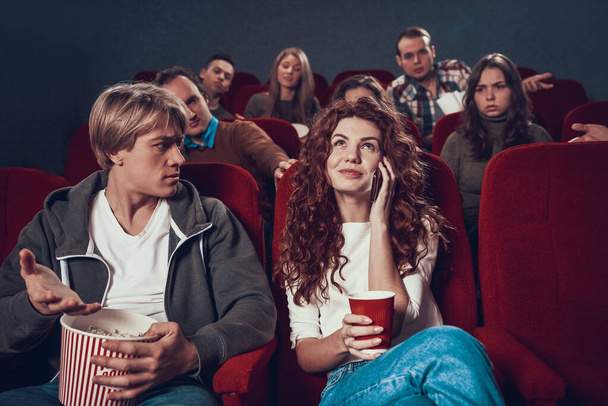 People in cinema ask woman to turn off phone. - Fotoğraf, Görsel