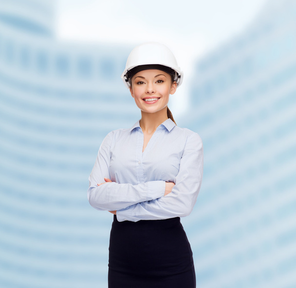 Friendly smiling businesswoman in white helmet - 写真・画像