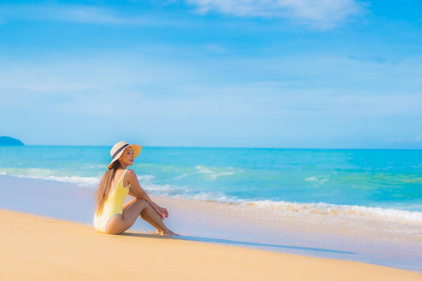 Portret mooie jonge Aziatische vrouw ontspannen glimlach vrijetijdsbesteding rond outdoor tropische zee strand oceaan in reizen vakantie - Foto, afbeelding