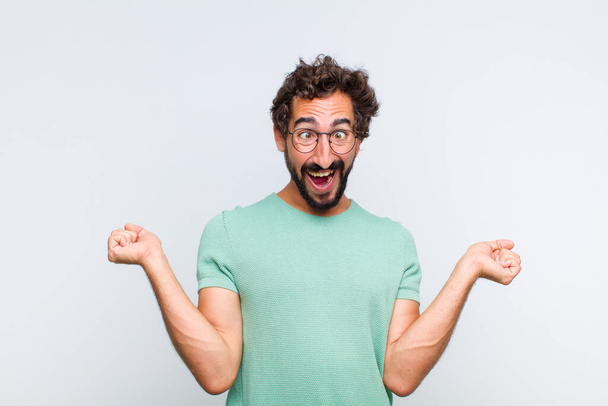 young bearded man looking extremely happy and surprised, celebrating success, shouting and jumping - Foto, immagini