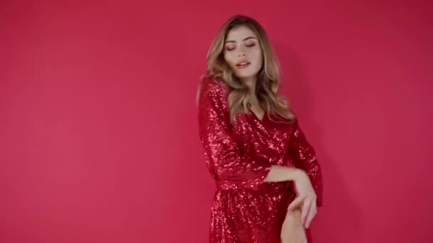 Woman in red dress dancing on red background  - Felvétel, videó