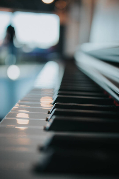 A vertical closeup shot of the piano keys - 写真・画像