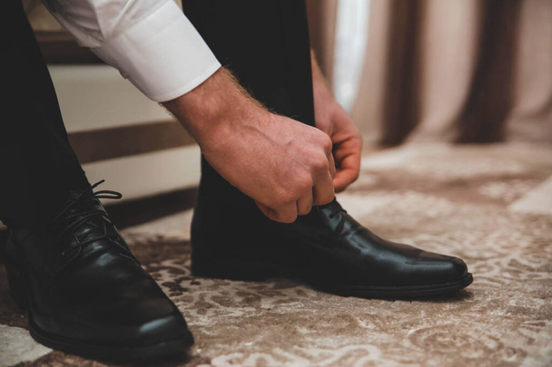 A selective focus shot of a groom preparing for his wedding - Photo, Image