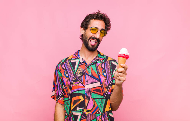 young bearded man with cheerful, carefree, rebellious attitude, joking and sticking tongue out, having fun - Foto, immagini