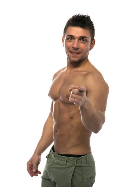 Confident, smiling muscular young man shirtless pointing finger to camera - Zdjęcie, obraz
