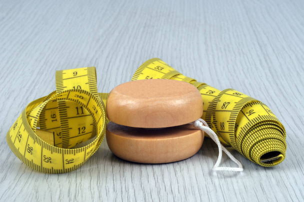 Yoyo diet concept with flexible tape measure close-up  - Photo, Image