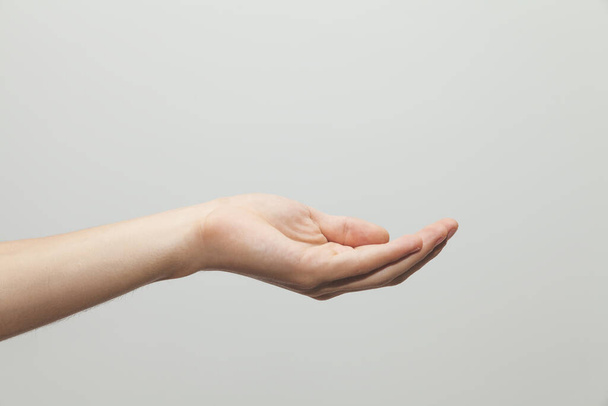 A closeup shot of a hand gesture on white background - Foto, imagen
