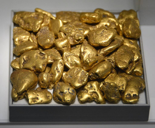 A gold nugget is a naturally occurring piece of native gold. Watercourses often concentrate nuggets and finer gold in placers. They are very valuable and are good investments.  - Photo, Image
