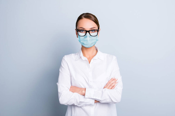 Photo portrait of woman with folded arms wearing blue face mask isolated on white colored background - Photo, image