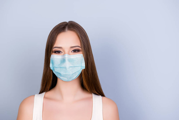 Close up of young gorgeous girl wearing blue face mask isolated on white colored background - Fotografie, Obrázek