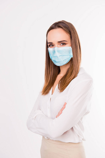 Vertical photo portrait of girl with folded arms wearing blue face mask isolated on white colored background - Fotografie, Obrázek