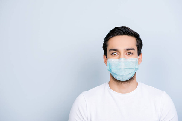 Portrait of man wearing blue face mask isolated on white colored background with blank space - Photo, image