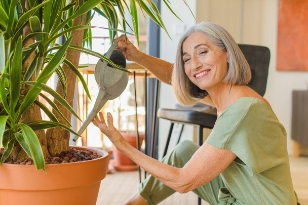 middle age woman with plants - Фото, зображення