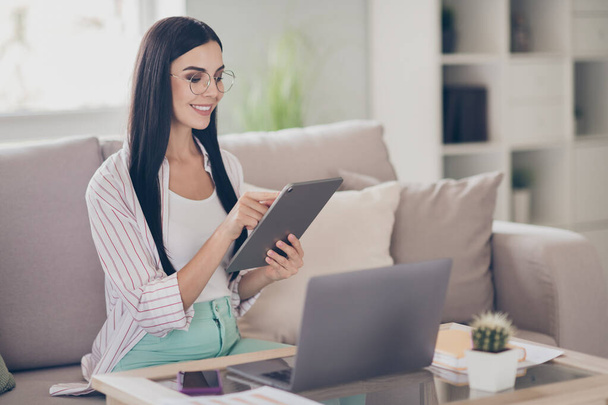 Photo of young business woman hold tablet typing touchscreen wear glasses shirt in home workstation indoors - Φωτογραφία, εικόνα