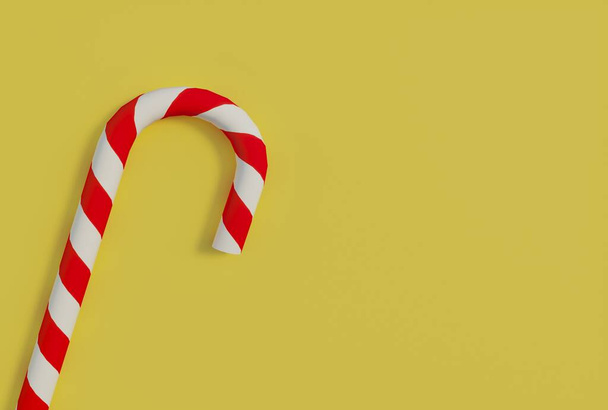 Candy stick close-up on yellow background with copy space. Christmas candy cane with white with red stripes. Christmas symbol. New year concept. 3D rendering. - Foto, Imagen
