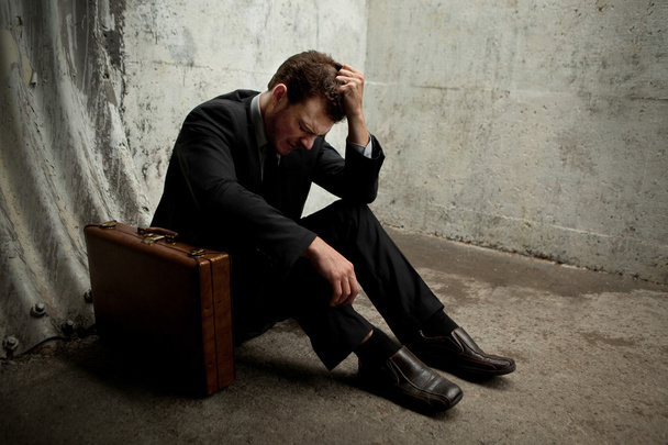 Very Desparate Businessman lying on the ground - 写真・画像