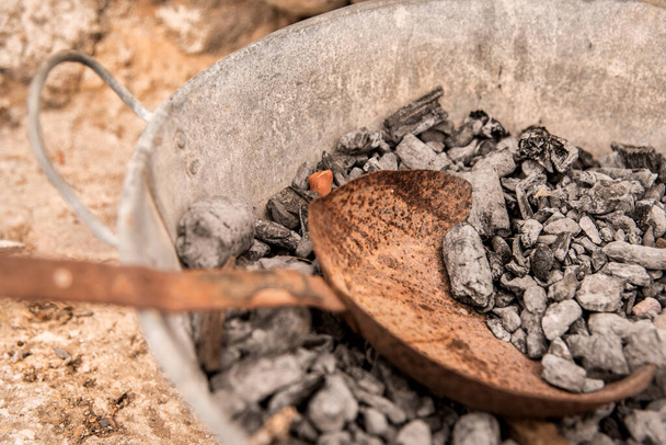 remains of fire inside an ancient bucket - Photo, Image