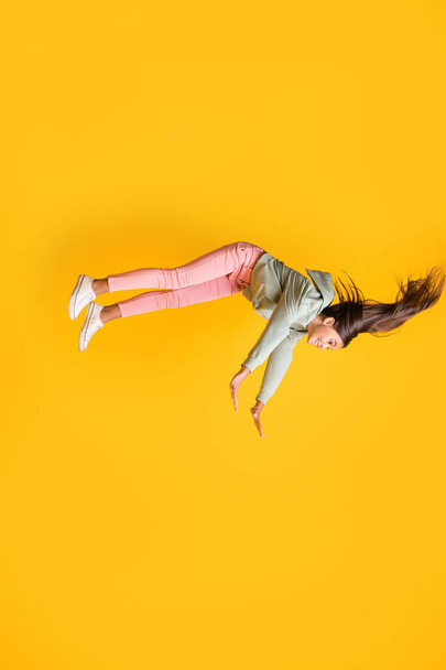 Vertical profile portrait of girl imagination flying style outfit isolated on vibrant yellow color background - Foto, Imagen