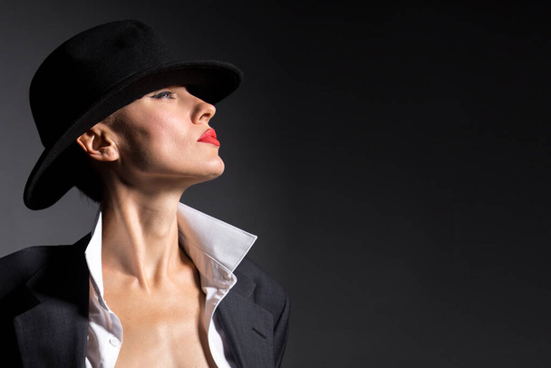 portrait of a beautiful woman in a hat and boyfriend jacket suit - Photo, image