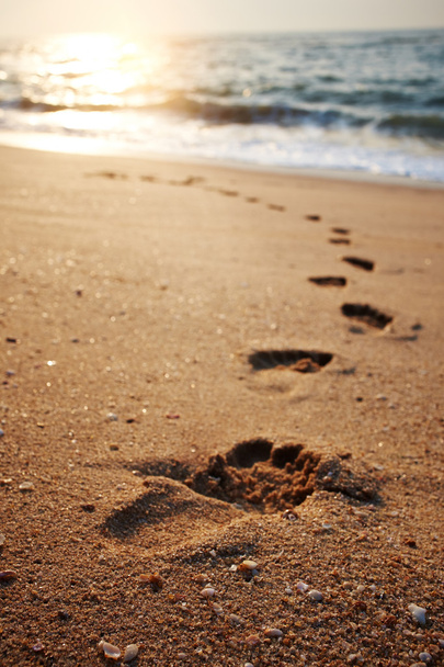 beach, wave and footsteps at sunset time  - Foto, imagen