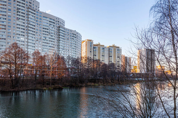 Pushkino, Russia, November 17, 2020. New multi-storey residential buildings on the banks of the Serebryanka river in sunset light - 写真・画像
