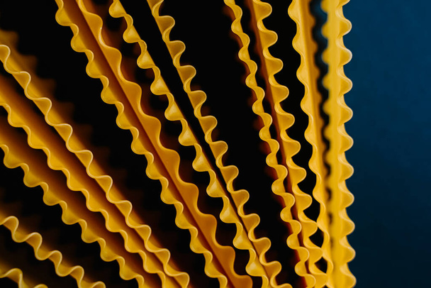 italian pasta tagliatelle on dark blue background - Foto, afbeelding