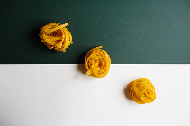 italian pasta tagliatelle on dark blue background - Фото, зображення