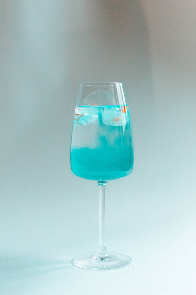 glass of water and blue curacao with ice - Fotoğraf, Görsel