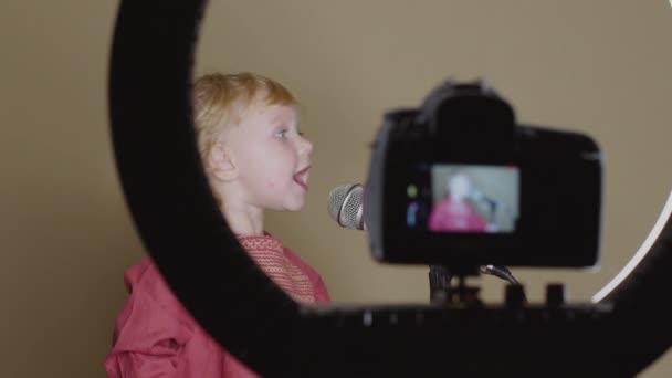 Cute little girl sing song into microphone, funny toddler enjoing broadcasting - Footage, Video