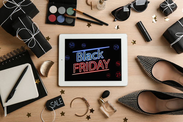 Flat lay composition with tablet, gifts and accessories on wooden background. Black Friday sale - Φωτογραφία, εικόνα