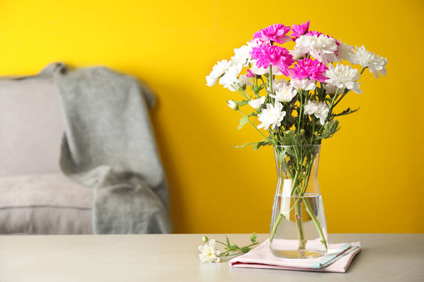 Beautiful bouquet of Chrysanthemum flowers on grey table indoors, space for text. Interior design - Foto, immagini