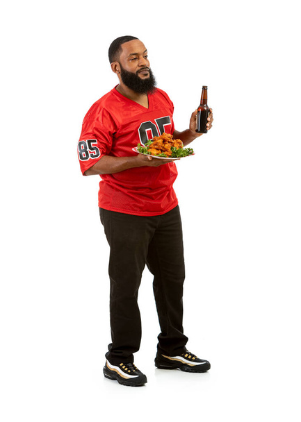 An African American man in a football team jersey in various poses. - Φωτογραφία, εικόνα