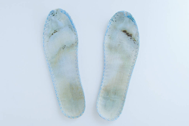 Dirty shoe insoles on a white background close-up. - Фото, изображение