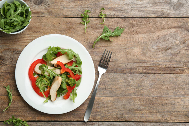 Delicious fresh chicken salad served on wooden table, flat lay. Space for text - Foto, immagini