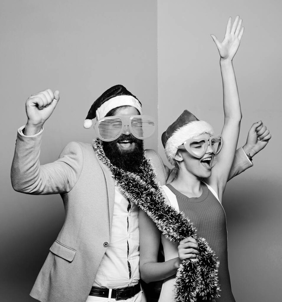 Christmas party office. Corporate holiday party ideas. Winter corporate party. Office christmas party. Happy man and woman wear santa hats and funny sunglasses. Manager tinsel celebrate new year - Fotografie, Obrázek