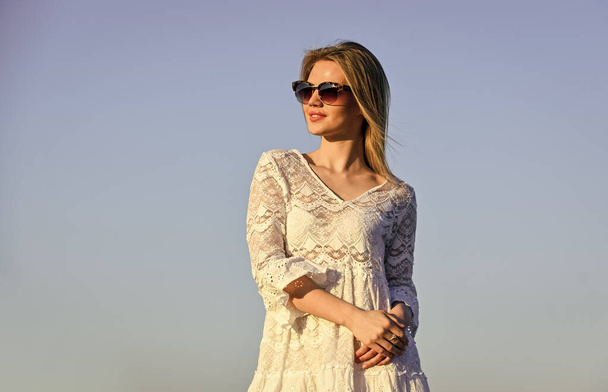 Girl white dress feel free. Leisure and rest. Summer relax. Sunny day. Girl blue sky background. Female health. Emotional girl. Happy. Carefree girl. Pretty woman fashionable sunglasses outdoors - Foto, imagen