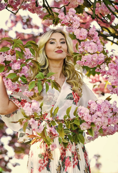 Pleasant spring day. spa and beauty treatment. soft skin care. healthy girl in cherry tree garden. vintage summer fashion. spring nature blossom in park. retro woman smell sakura flowers - Foto, immagini