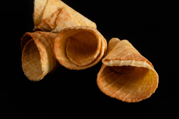 Collection of homemade empty ice cream cones isolated on black background. - Fotografie, Obrázek