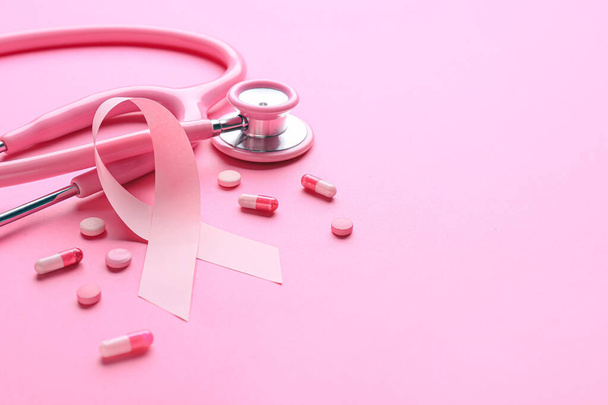 Pink ribbon, remedy and stethoscope on color background. Breast cancer awareness concept - Photo, Image