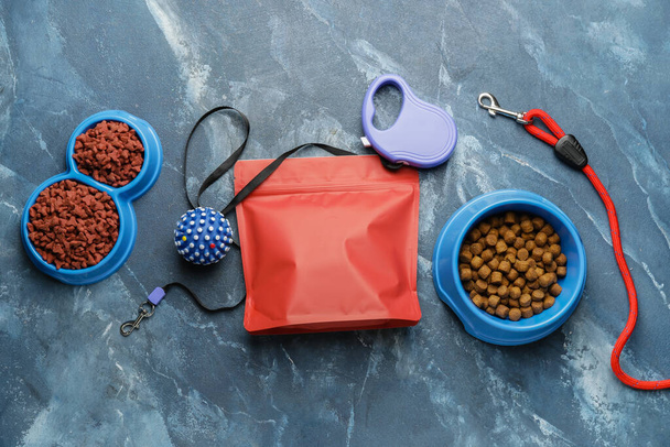 Lekker huisdier voedsel en accessoires op kleur achtergrond - Foto, afbeelding