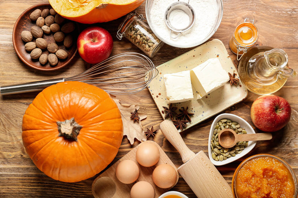 Ingredients for preparing pumpkin pie on wooden background - Photo, Image