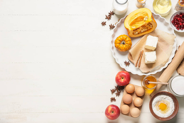 Ingredients for preparing pumpkin pie on white wooden background - Photo, image