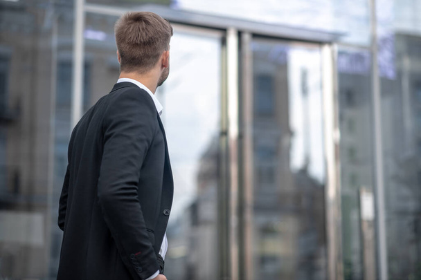 Young businessman looking at the business center entrance - Foto, Imagen